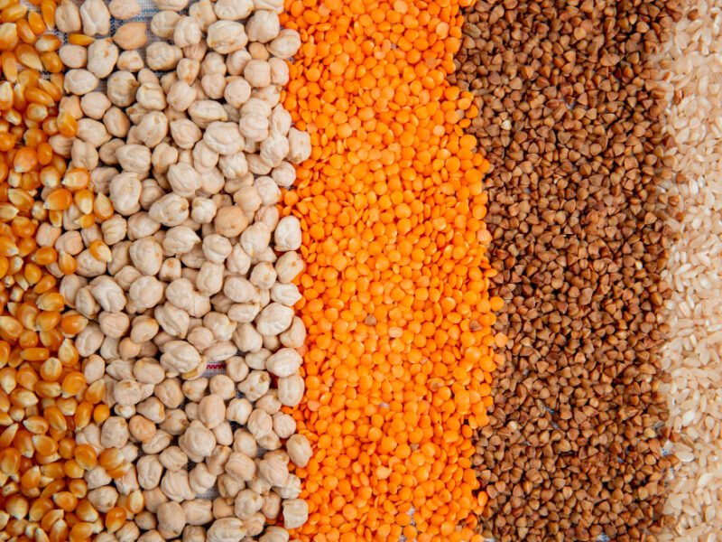 background-different-types-groats-corn-seeds-chickpeas-red-lentils-buckwheat-rice-top-view