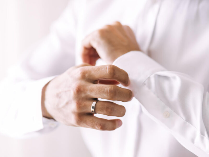 morning-groom-wedding-day-hands-man-straightens-his-sleeve-white-shirt