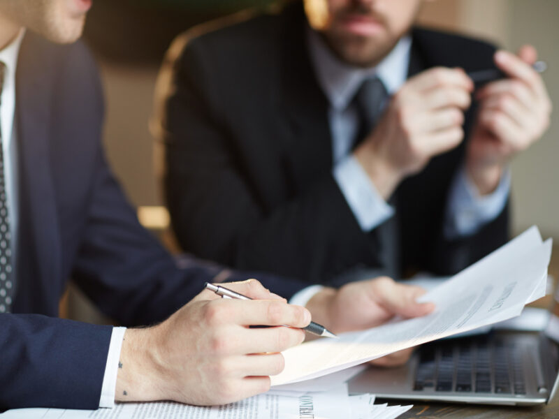 successful-business-partners-discussing-contract